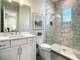 Our guest bathroom features a stylish vanity, full-size toilet, and walk-in shower for a luxurious bathing experience.