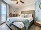 King bed with ceiling fan.