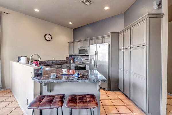 Fully Equipped Kitchen with Stainless Steel Appliances and Bar Seating for 2