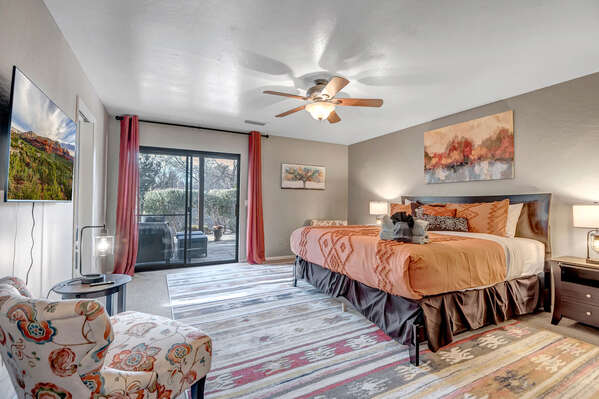 Master Bedroom with King Bed, Smart TV, Walk-in Closet, Access to Outdoor Patio, and En Suite Bathroom