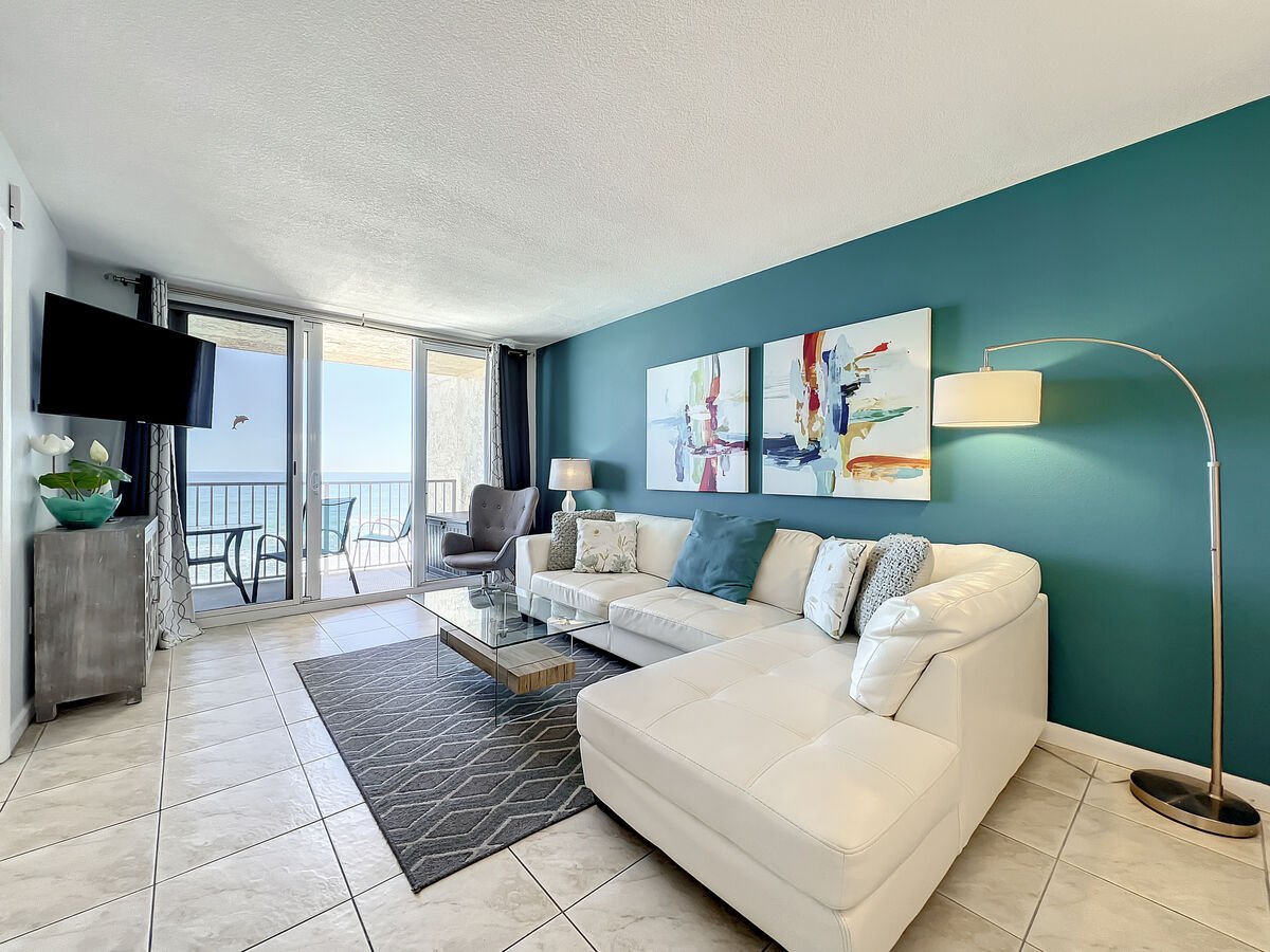 Cozy up with a view! Our living room features a comfortable sectional, ideal for lounging while soaking in the ocean vistas.