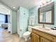 Vanity with storage and full size toilet. Access to master bedroom.