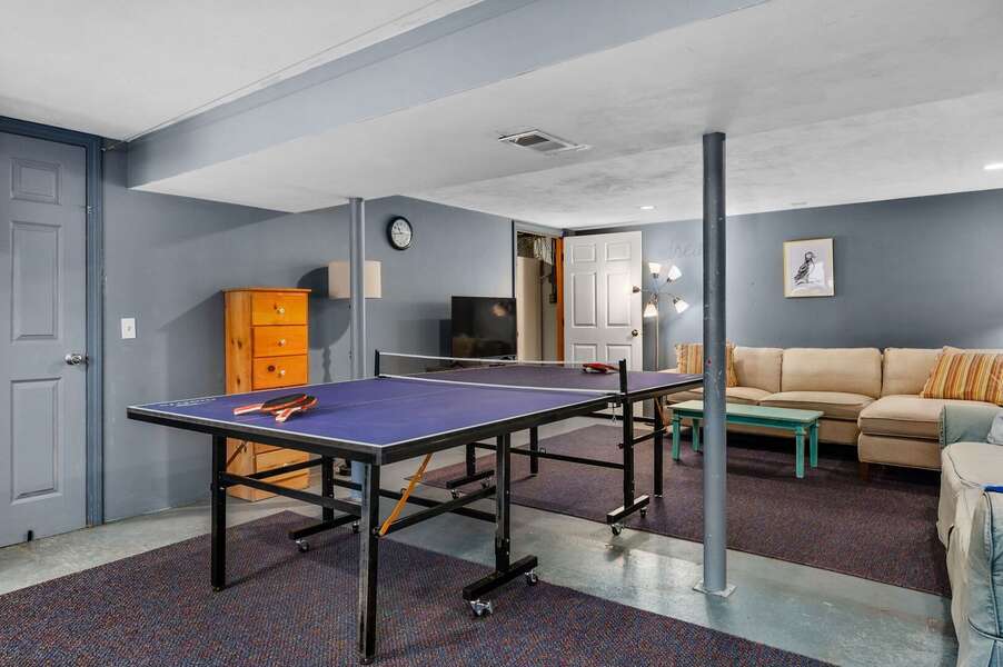 View to the interior entry of the game room where comfortable couches offer viewing of a ping pong match or the large flat screen TV - 14 Quail Nest Run Harwich Cape Cod-Hawksnest Hideaway-NEVR