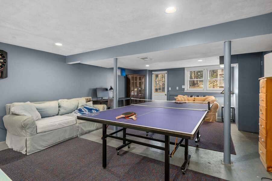 The lower level game room with plenty of seating, desk space, a ping pong table, an electronic dart board and access to the backyard as well - 14 Quail Nest Run Harwich Cape Cod-Hawksnest Hideaway-NEVR