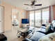 Open living room with ceiling fan. Views of the balcony.