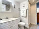 Sink vanity with storage in mirror and cabinets. Full size toilet.