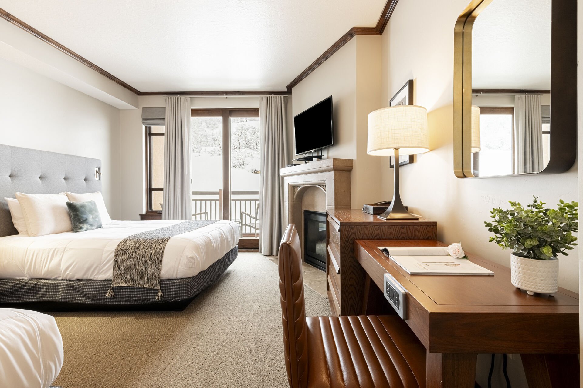 Guest Suite 4 (Unit C) with two queen beds, a desk, and a private balcony