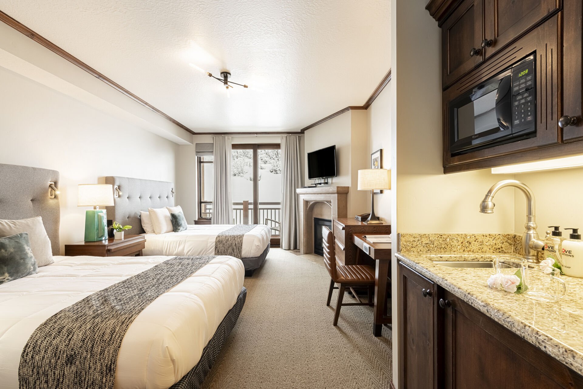 Guest Suite 4 (Unit C) wet bar with a mini fridge, Keurig and Drip coffee maker, a microwave, and private bathroom