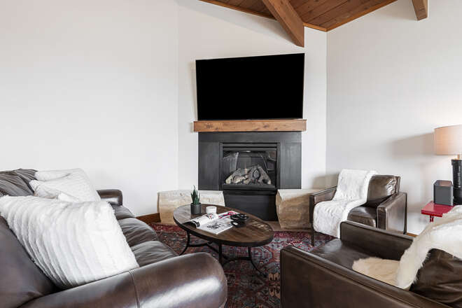 Main Level - Living Area with Gas Fireplace, Leather Sofa, and Smart TV