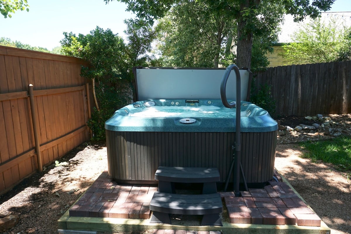 Our private outdoor hot tub, the perfect place to unwind and enjoy the serene backyard