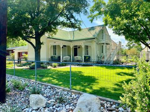 Step outside and take in the picturesque beauty of the Victorian house, surrounded by lush greenery and vibrant flowers that add to its enchanting allure