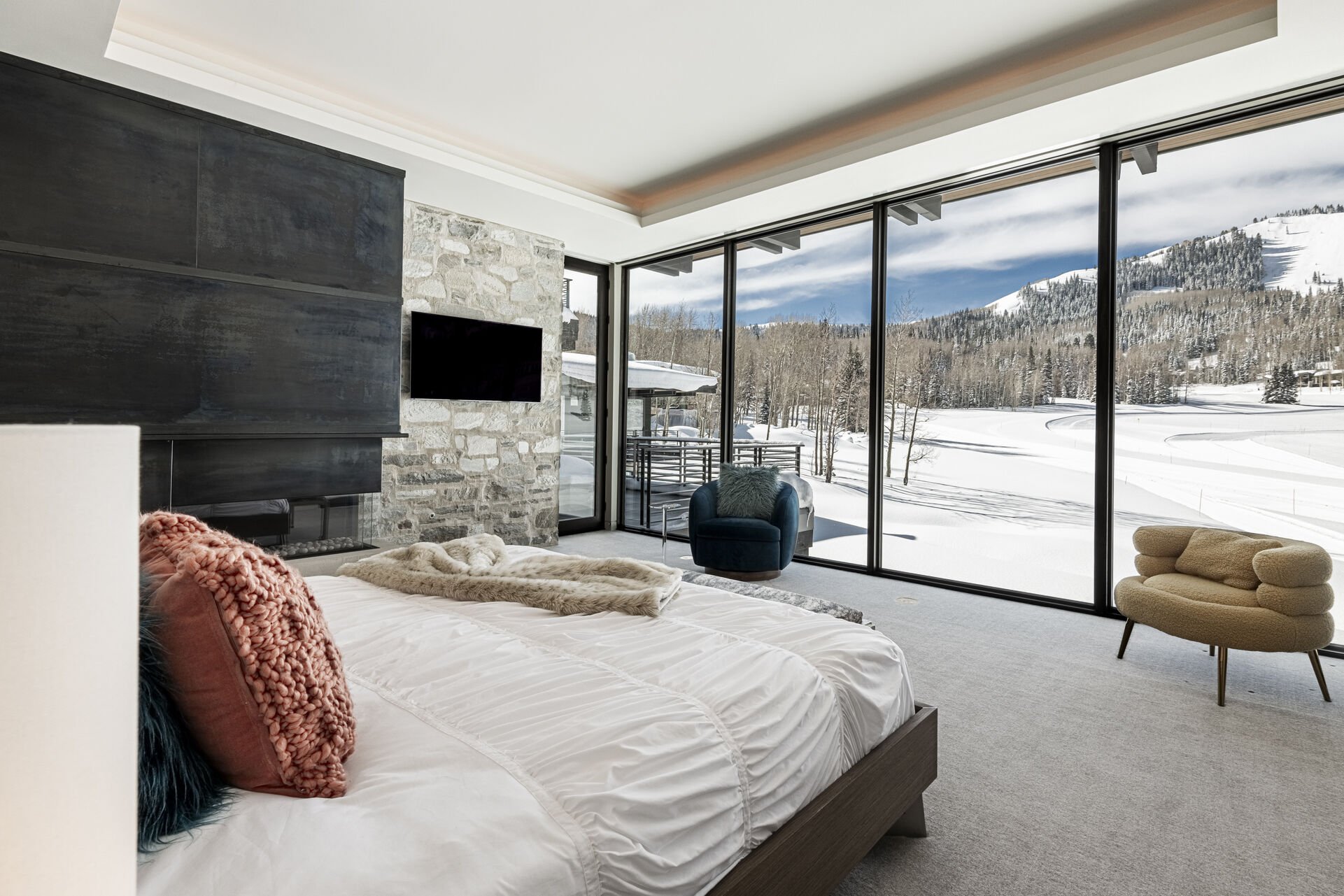Main level master suite 3 with a king bed, gas fireplace and Smart TV