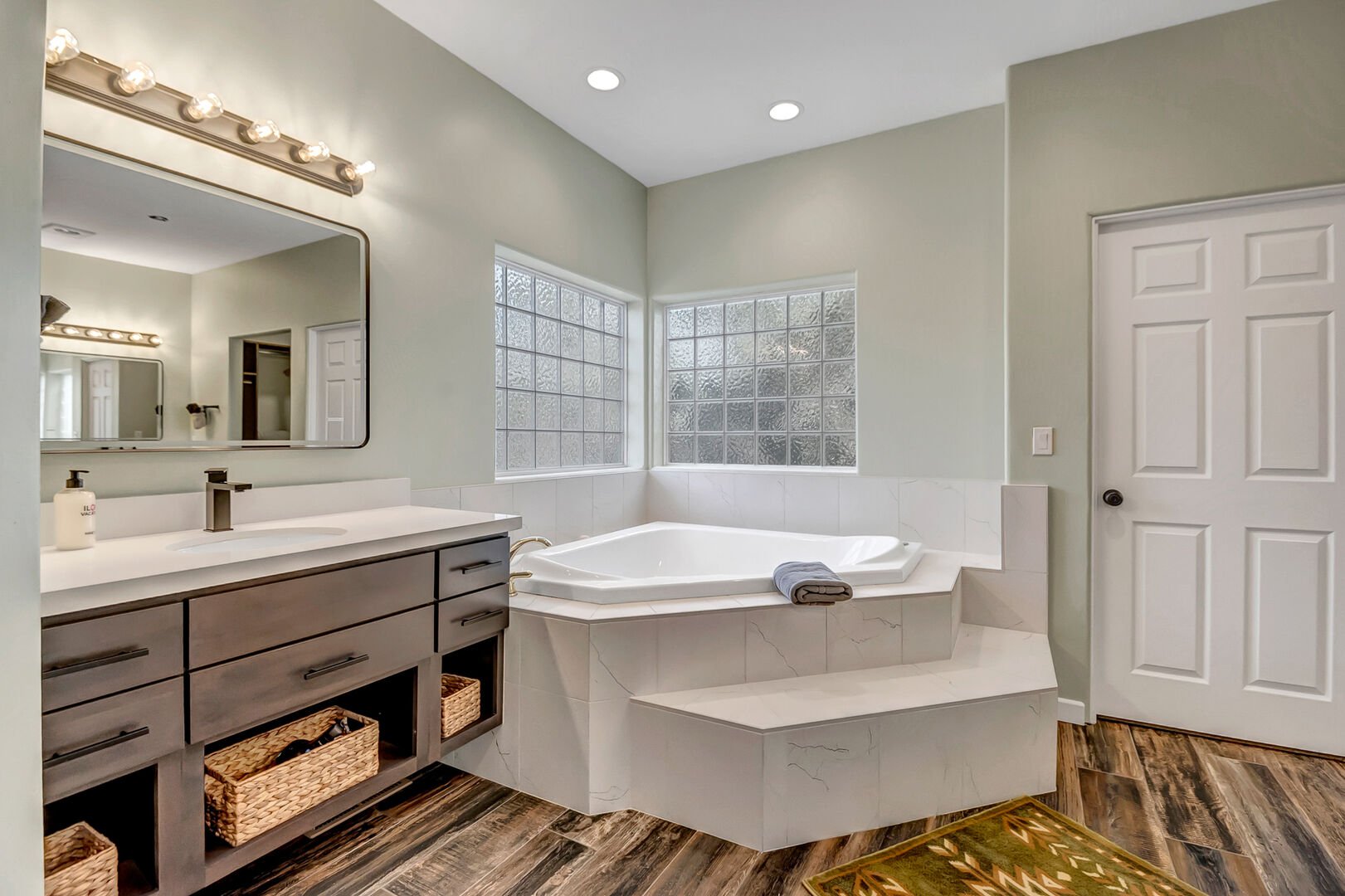 Master bathroom with two separate vanities, soaking tub, and separate walk-in shower