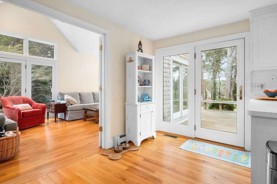 Gorgeous glass doors leading to the deck and a convenient nearby canine corner for your furry family - 853 Route 28 Harwich Port Cape Cod - Sandy Spot