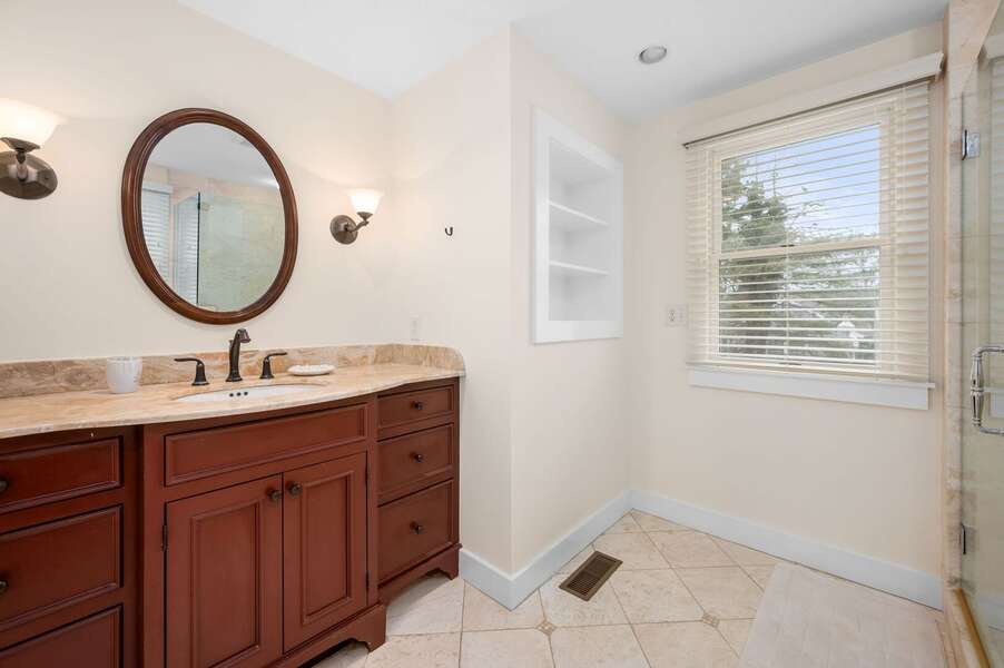 Bathroom #1 in the Primary bedroom provides storage and counterspace for toiletries - 853 Route 28 Harwich Port Cape Cod - Sandy Spot