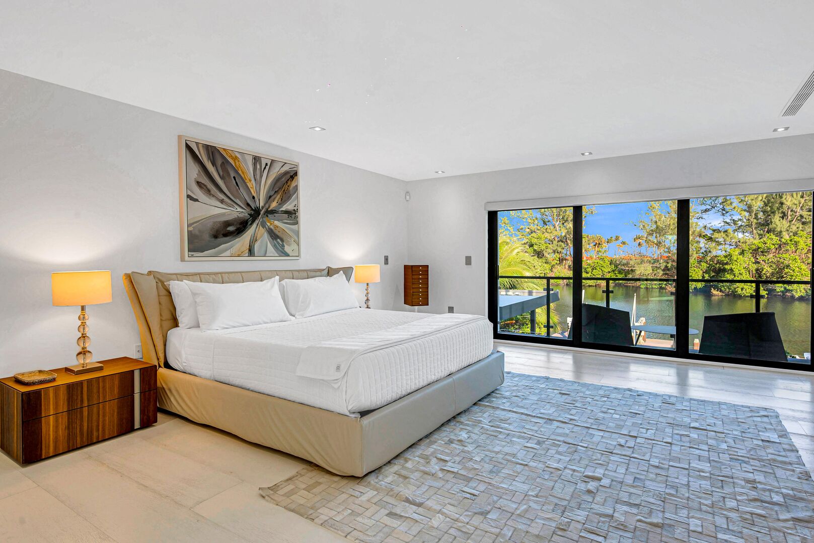 The primary bedroom with its balcony is overlooking the heated pool and the Mayan Lake.