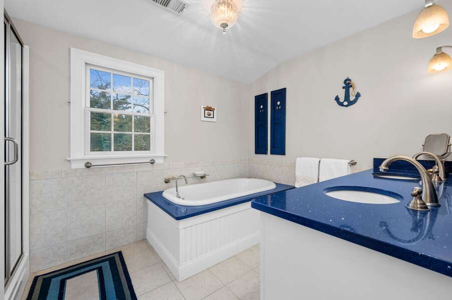 Bathroom #3 is the Primary en suite full bathroom with double vanity, large tub and separate shower - 92 Hoyt Road Harwich Port Cape Cod - Apricari - NEVR