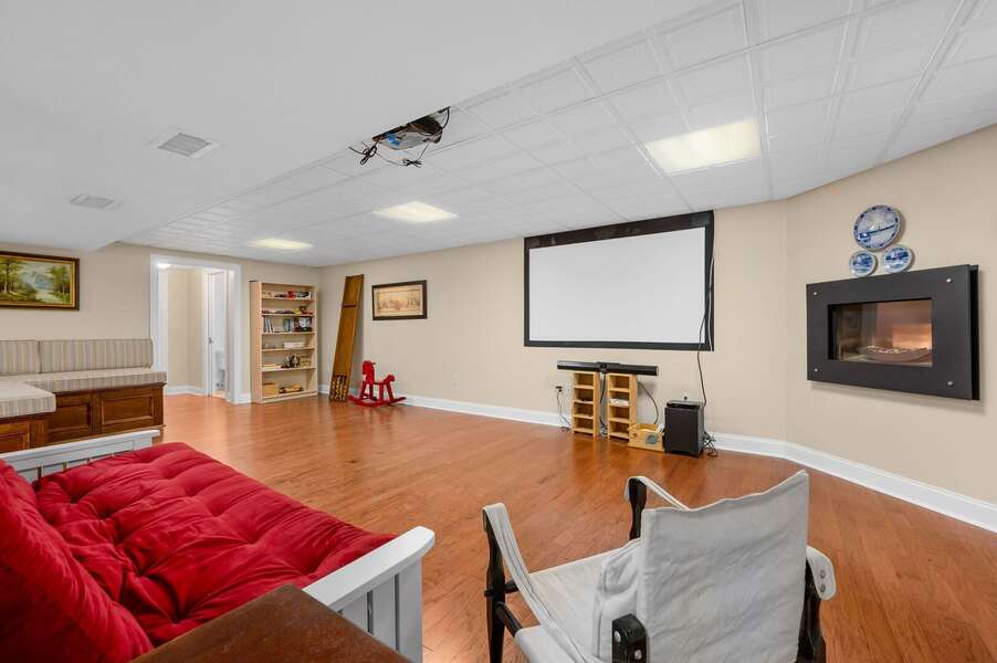 Part of the fantastic family room on the lower level including projection screen and built in fireplace - 92 Hoyt Road Harwich Port Cape Cod - Apricari - NEVR