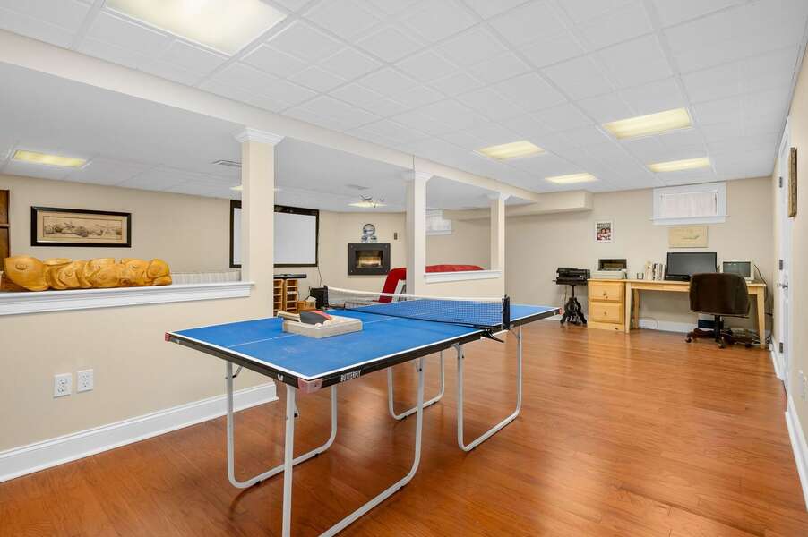 The other half of the family room in the lower level which offers a ping pong table and remote work space - 92 Hoyt Road Harwich Port Cape Cod - Apricari - NEVR