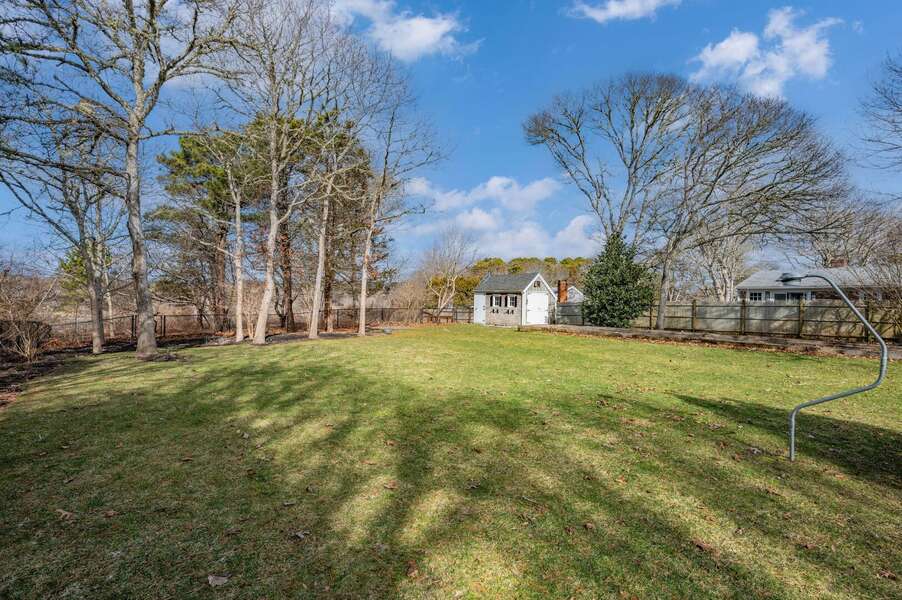 View to back gate of fenced yard, leading to the overlook of conservation land (new photos to come in the Spring when plantings are in bloom!) - 92 Hoyt Road Harwich Port Cape Cod - Apricari - NEVR