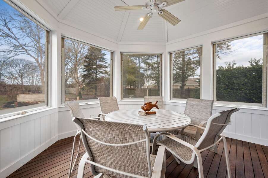Wonderful sunroom located off of the dining room in this home and offering additional dining space or covered space for supervising kids in the pool - 92 Hoyt Road Harwich Port Cape Cod - Apricari - NEVR
