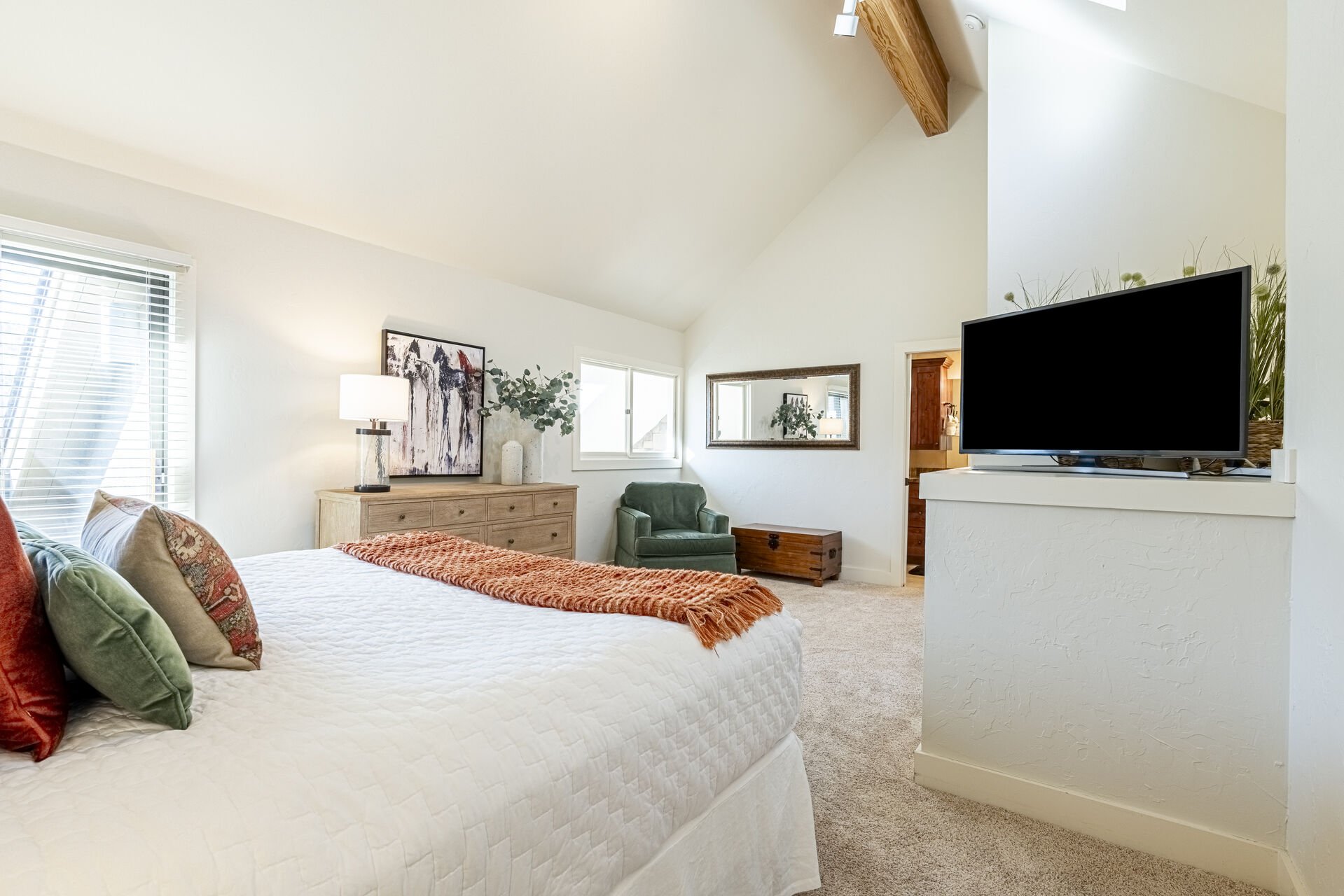 Master Bedroom (third level) with king bed and smart TV bathed in natural light