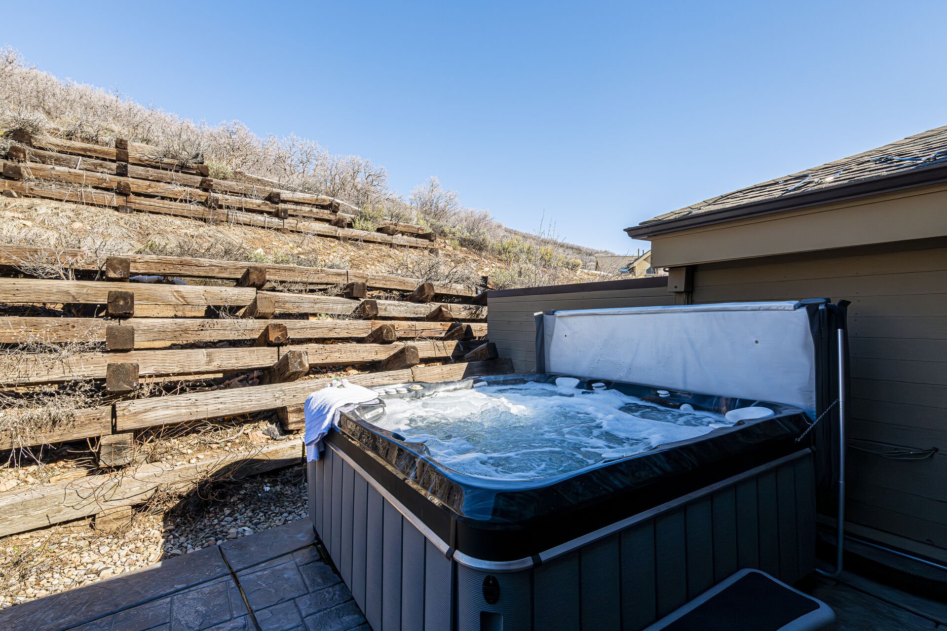 Second level heated back patio with private hot tub