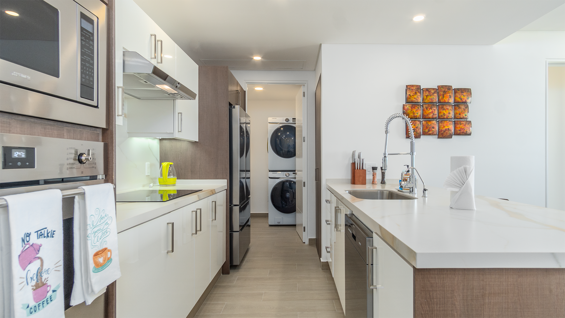 pass through the kitchen to the utility room and its sink, washer, and dryer