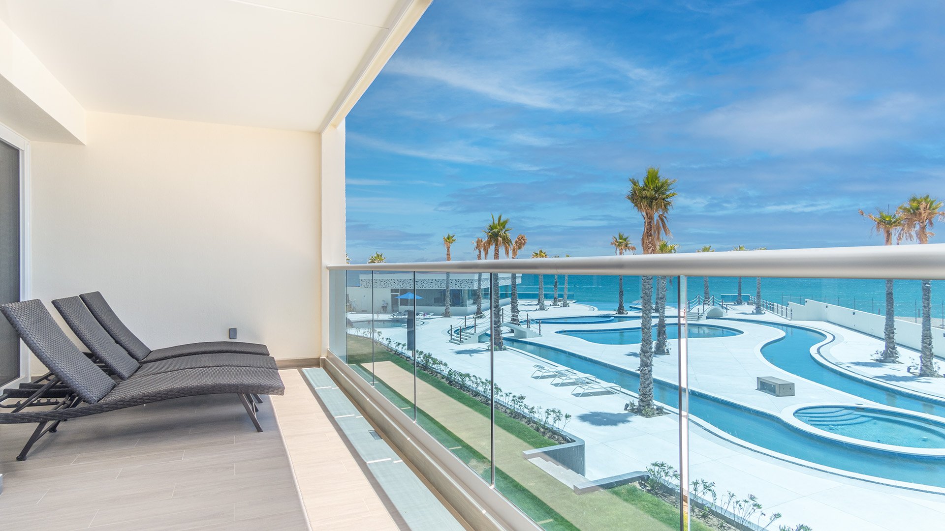 The lazy river wind below your balcony with its chaise lounge chairs.