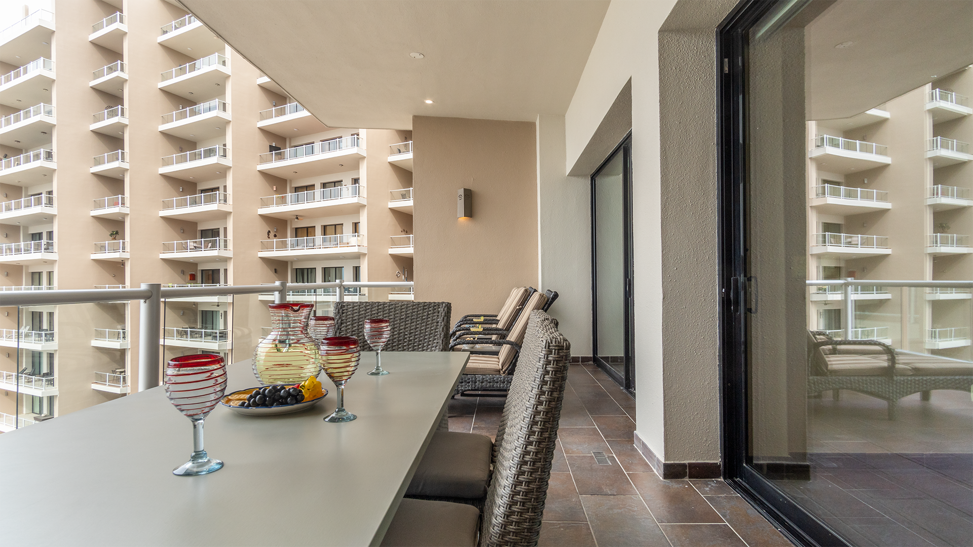 The spacious patio with chaise lounge chairs and a full dining table.