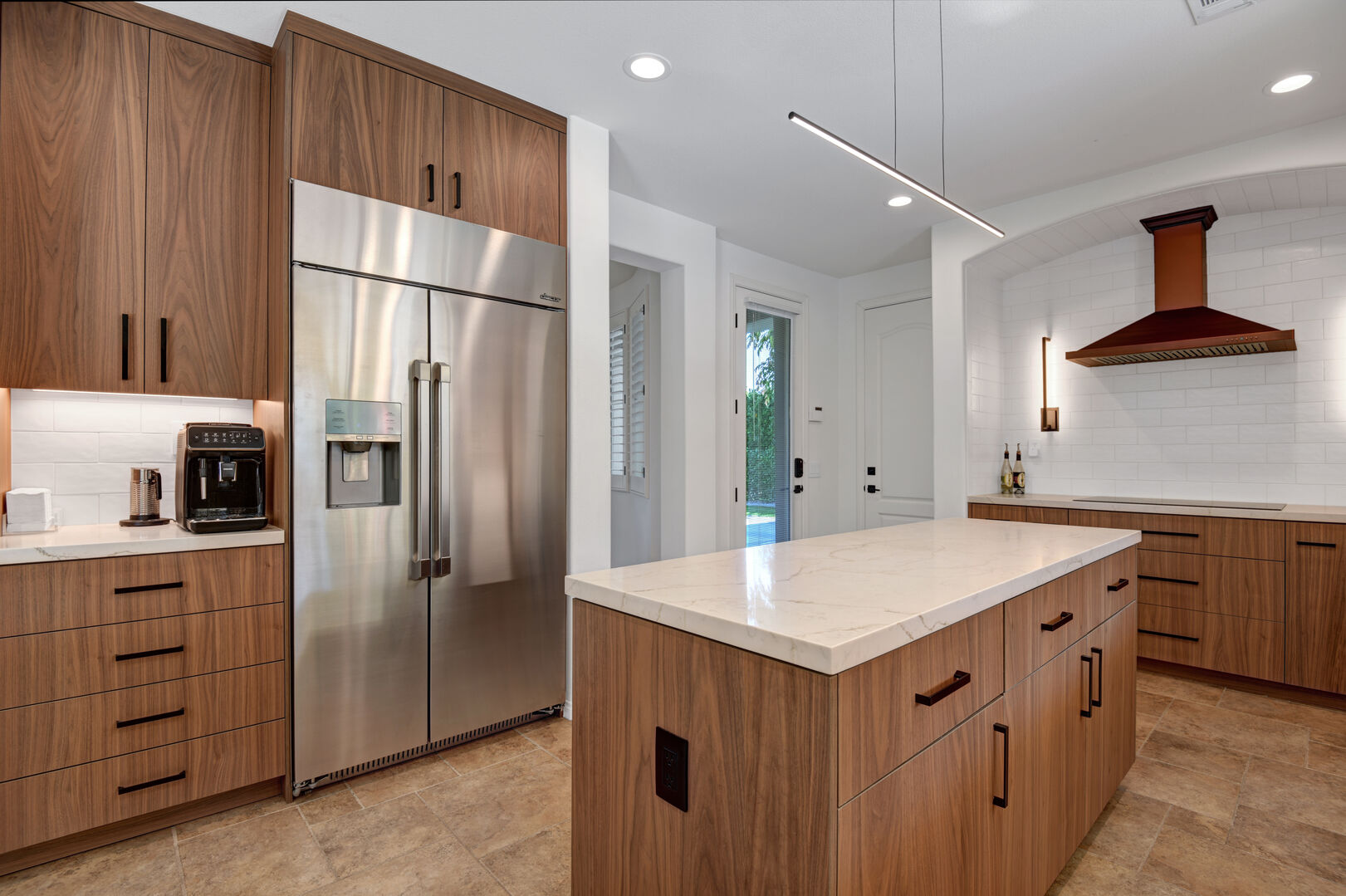 Experience culinary luxury with the large side-by-side fridge and ample counter space in the modern kitchen.