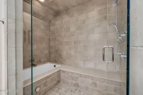 Soaking tub inside an oversized steam shower