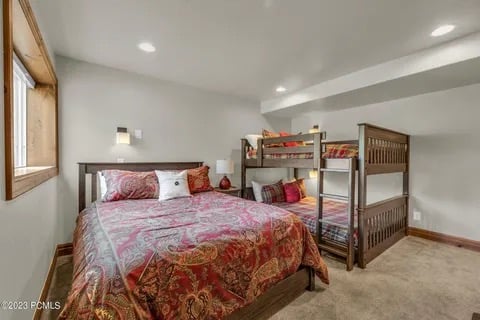 1st level Bedroom 4 with a queen bed and queen over queen bunk beds and private bath