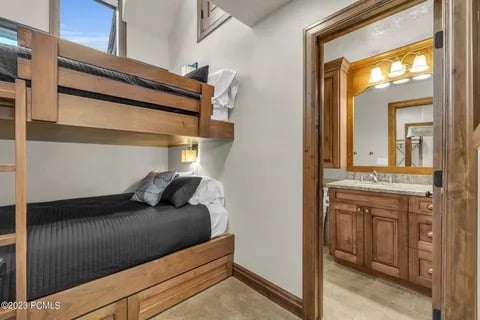 Main level bunk room with queen over queen bunk beds and private bath
