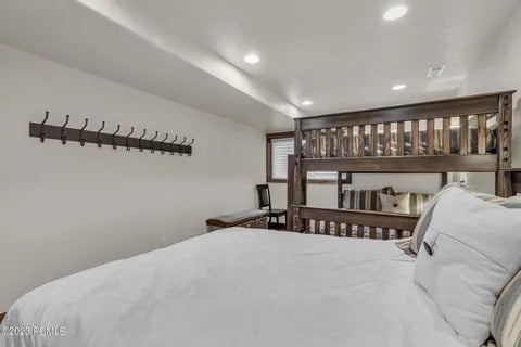 1st level Bedroom 3 with a queen bed and queen over queen bunk beds and private bath