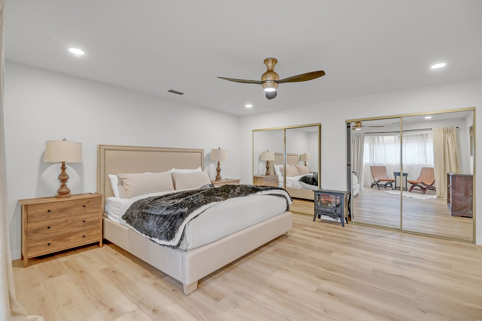 Master Bedroom with king bed, smart TV, electric fireplace, and en suite bathroom