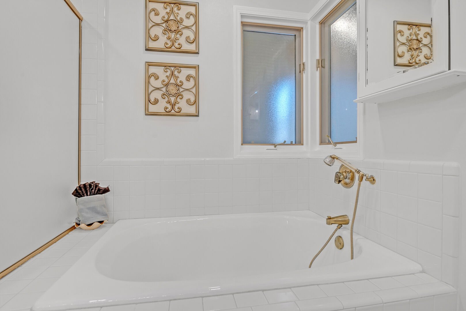 Master bathroom with single vanities, soaking tub, and separate shower