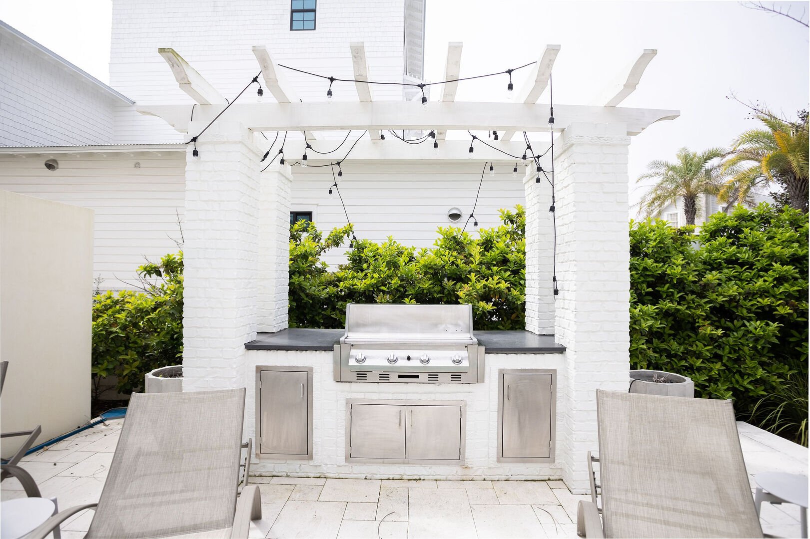 Outdoor kitchen with a gas grill.