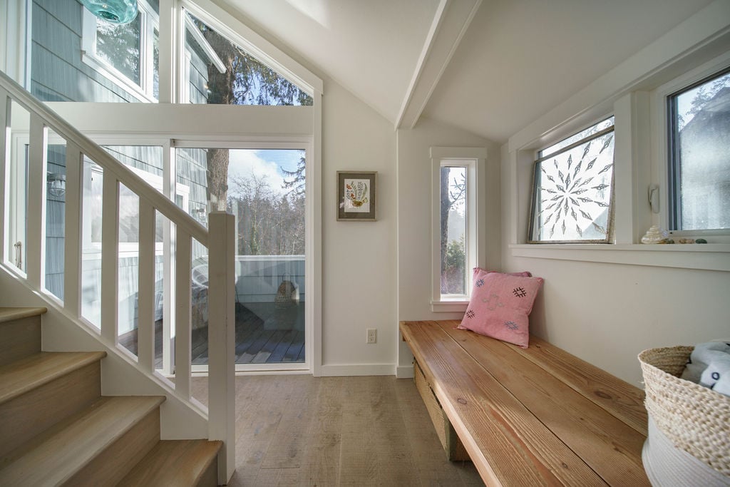 As you enter the home you are greeted by cozy decor and large windows opening to the deck. the stairs take you to the2nd floor where the bedrooms and 2 bathrooms are found.