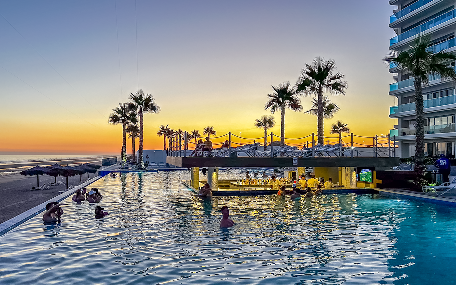 The pool and swim up bar at sunset