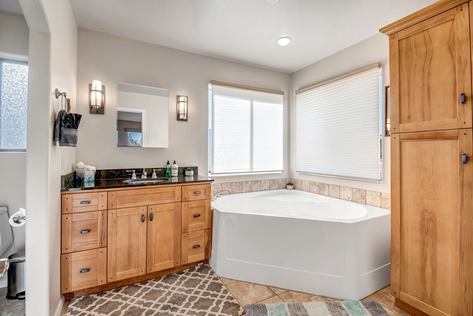 Master bathroom with single vanity, tub and separate shower