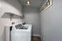 Laundry room includes top loader washer.