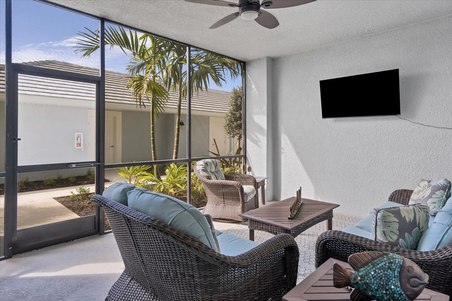 Front lanai features ample seating and a 50-inch Smart TV. Great for entertaining