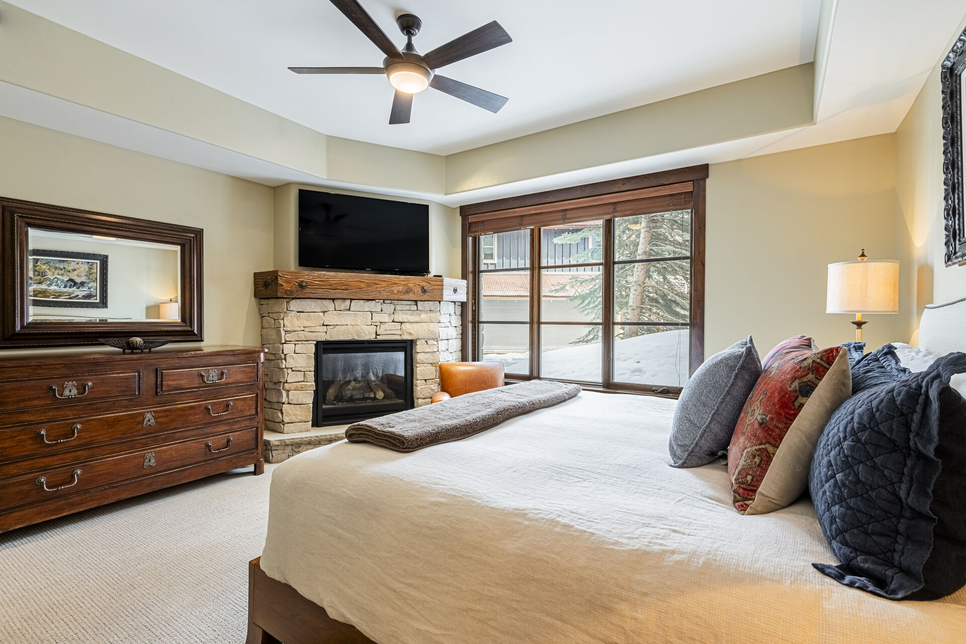 Master bedroom with a king bed, gas fireplace and Smart TV