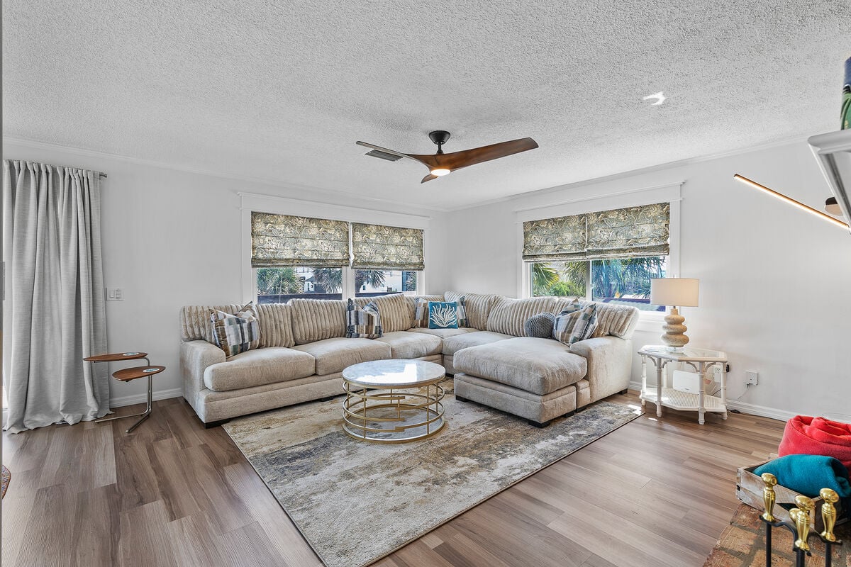 Sun-filled retreat with modern amenities for comfort. Relax on spacious couch and enjoy entertainment on the smart TV. With connection to the kitchen, dining area, and balcony, this space promises a serene escape for relaxation and rejuvenation.