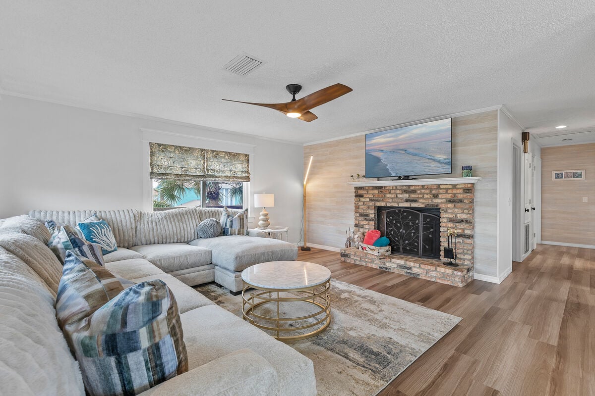 Sink into the plush couch and unwind with entertainment on the smart TV. Bright and airy, this space seamlessly connects to the kitchen, dining area, and balcony, offering an open retreat for relaxation and leisure.