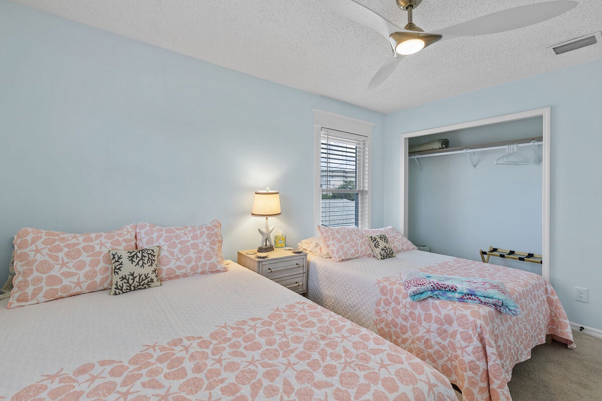 Sink into comfort in this spacious bedroom boasting a queen and full bed. Wind down with TV entertainment, lounge on the sitting bench, and store your belongings with ease in the ample closet space.