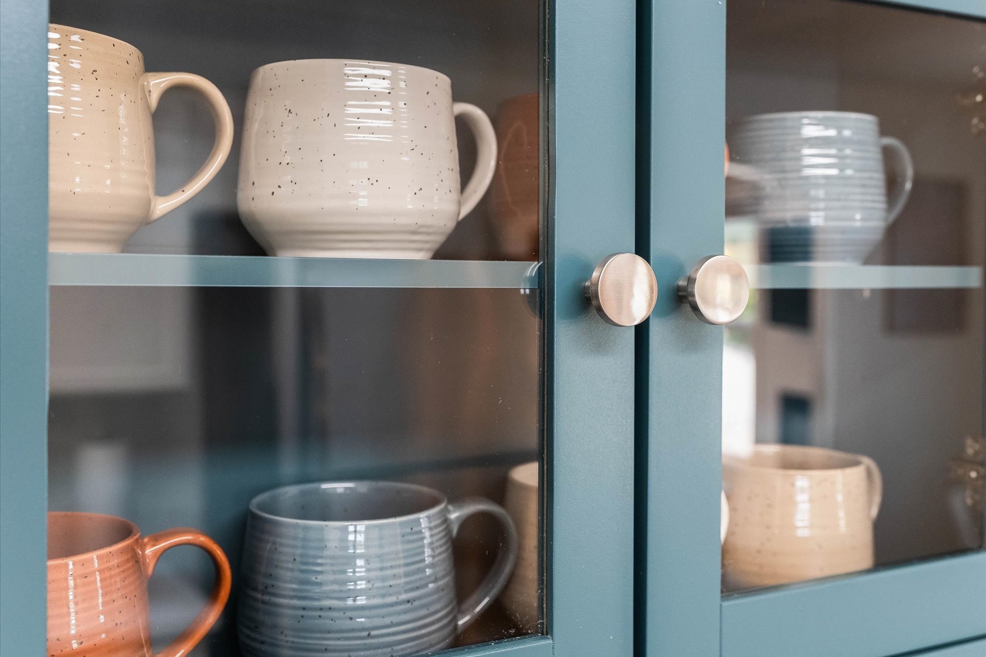 Up close of mugs in cabinets