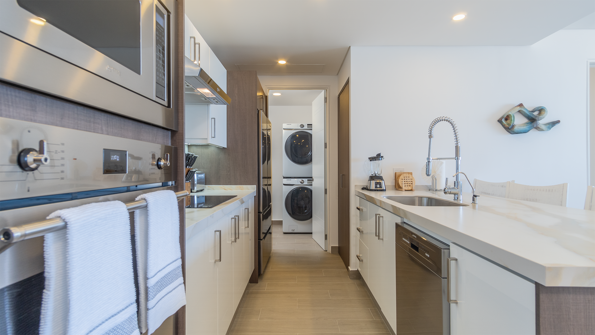 Pass through the kitchen to the washer and dryer