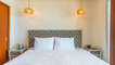 Guest room with king bed and direct access to balcony.